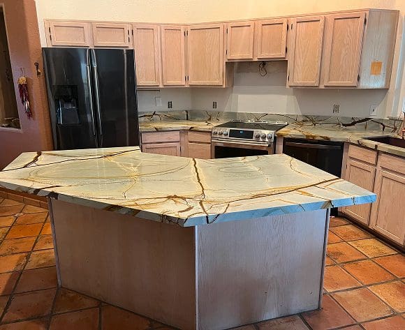 Kitchen with marble island and wooden cabinets.