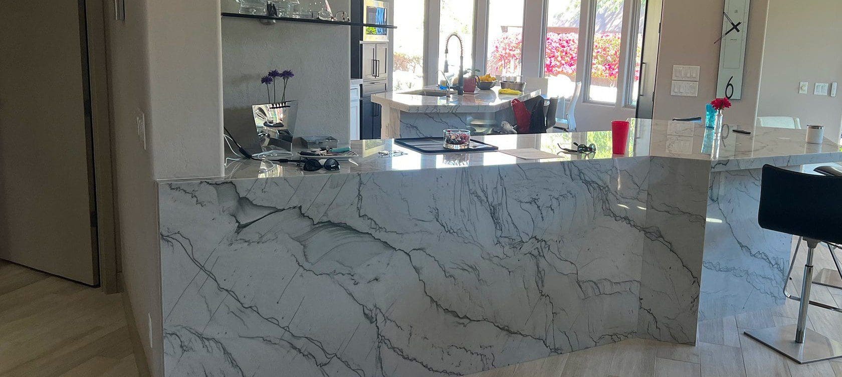 White marble kitchen island with bar stools