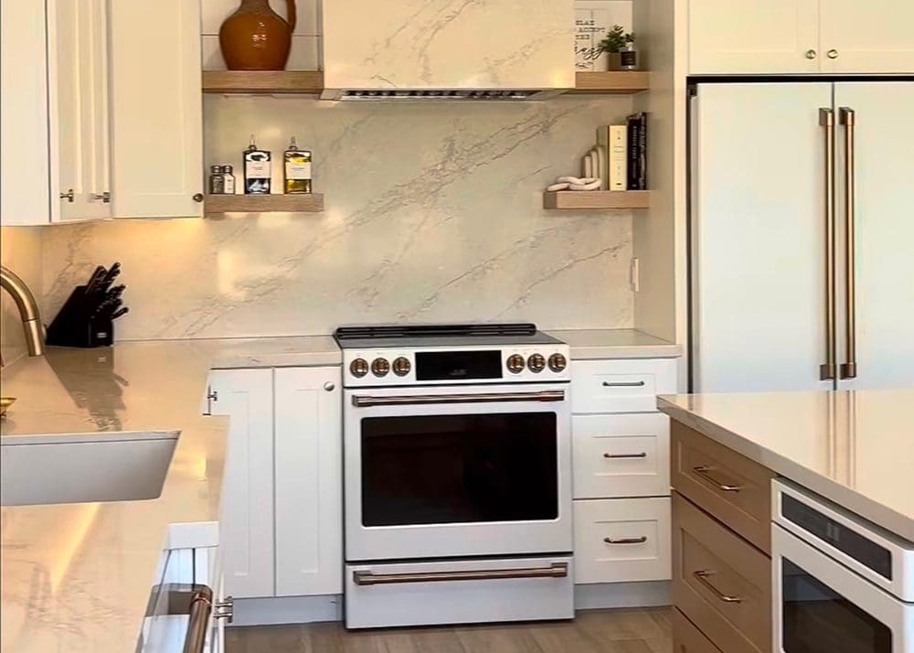 Modern kitchen with white cabinetry and a stainless steel stove.