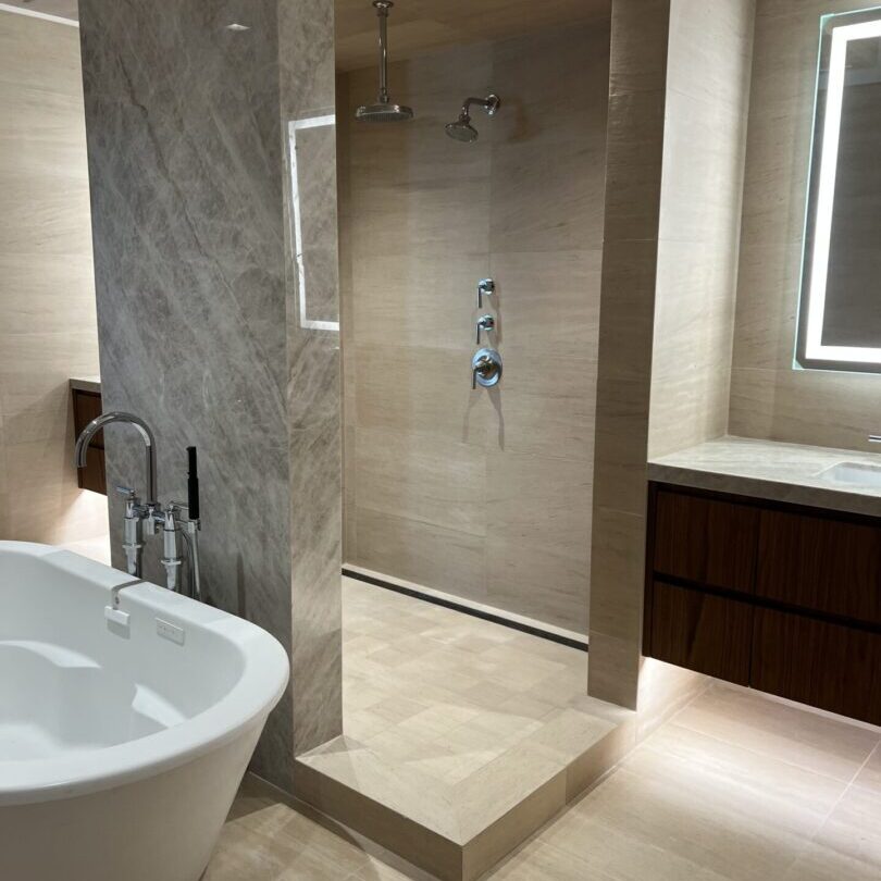 Modern bathroom with freestanding tub and walk-in shower.