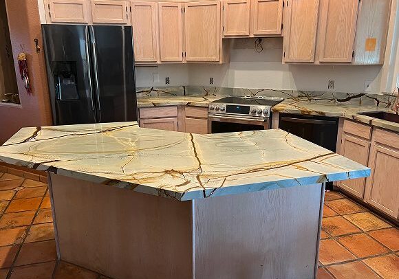 Kitchen with marble island and wooden cabinets.